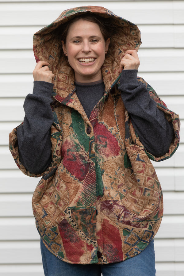 90's inspired comforter turned into an oversized poncho featuring cozy oversized hood, pockets and asymmetrical hood, made in canada