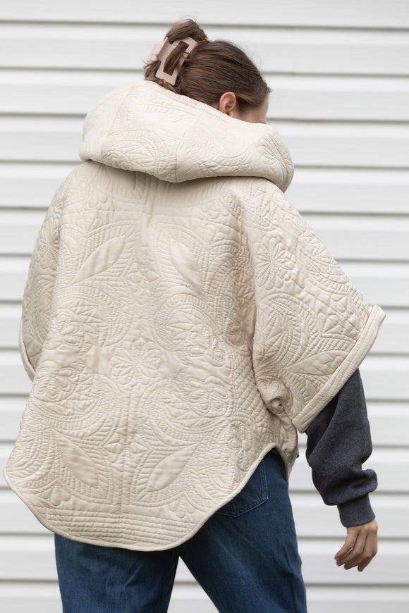 upcycled poncho, featuring a big hood, pockets and oversized style, made from quilts and scrap fabric, made in canada