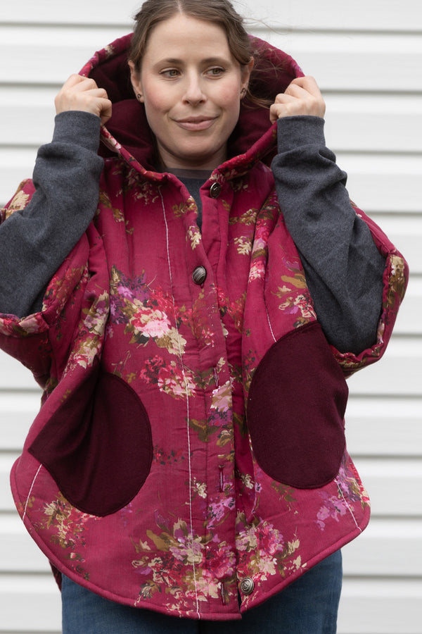 burgundy floral comforter upcycled into oversized poncho, featuring a big hood and pockets and perfect layering style. upcycled and made in canada