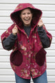 burgundy floral comforter upcycled into oversized poncho, featuring a big hood and pockets and perfect layering style. upcycled and made in canada