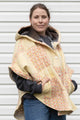 oversized upcycled quilted poncho with big hood and pockets. made from yellow and orange quilt with colourful daisies, made in canada