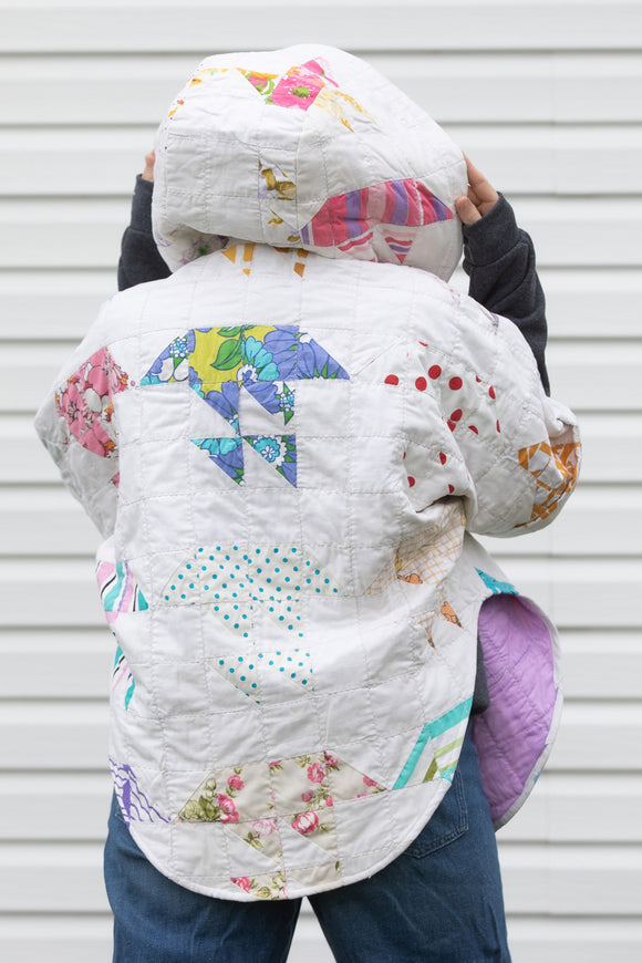 colourful pastel poncho, featuring a big hood, pockets and oversized style, upcycled from a stunning quilt and made in canada