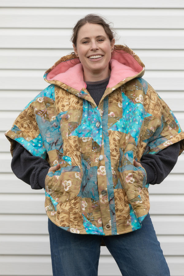 blue and gold quilt upcycled into the perfect poncho, it features a cozy hood, pockets and the perfect cut for layering up all your fall outfits, made in canada