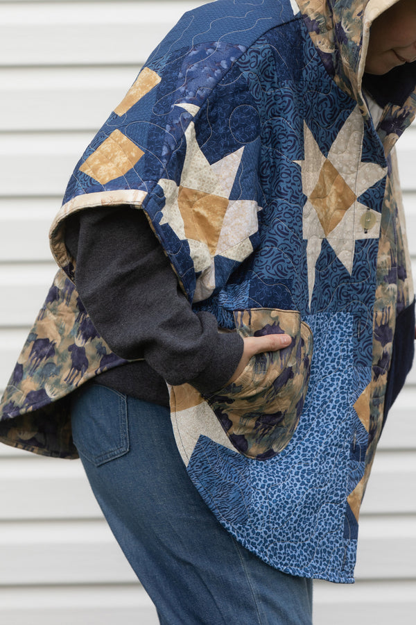 blue quilt repurposed into clare poncho, features oversized fit meant for layering, made in canada