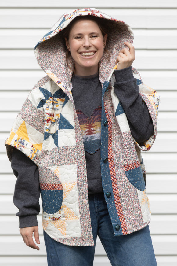 yellow and red star quilt upcycled into clare poncho, featuring a big hood, pockets and oversized style, upcycled and made in canada