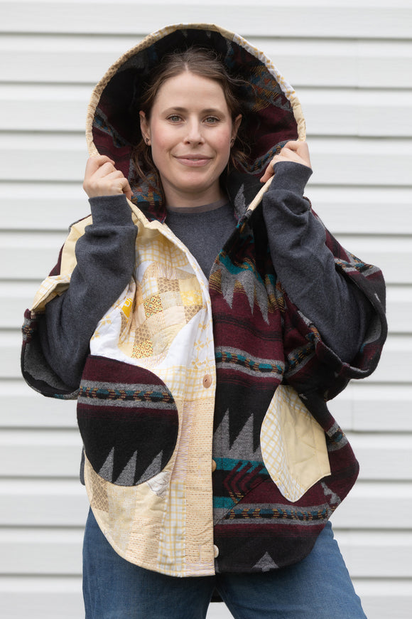 oversized upcycled quilted poncho, made from scrap fabric, yellow quilt with burgundy patterned fabric, repurposed in canada