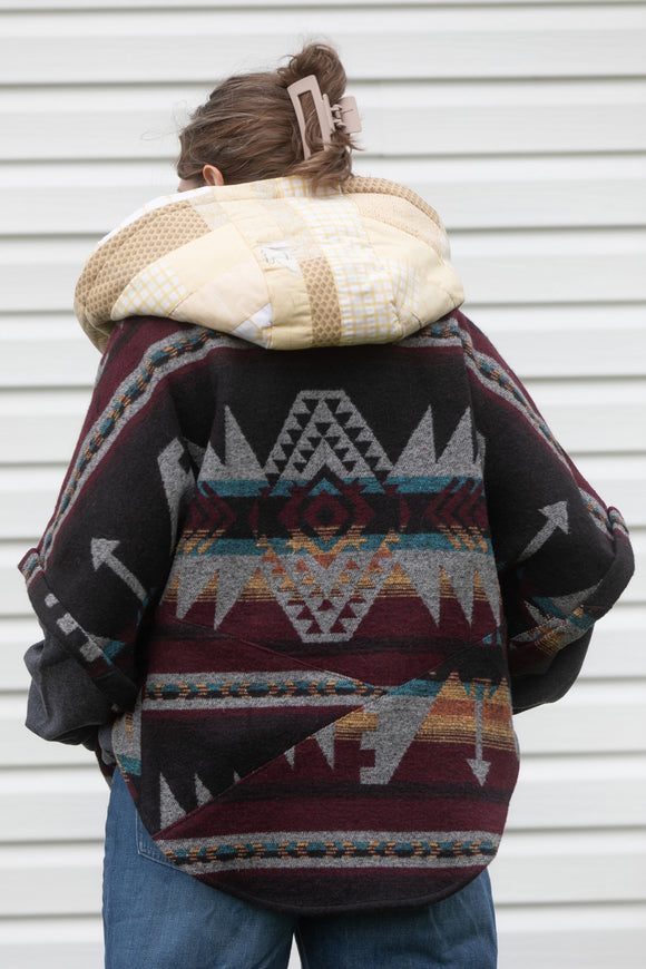 oversized upcycled quilted poncho, made from scrap fabric, yellow quilt with burgundy patterned fabric, repurposed in canada