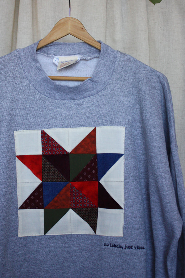 grey sweater with colourful quilt block on the front, repurposed secondhand sweater, upcycled clothing, made in canada