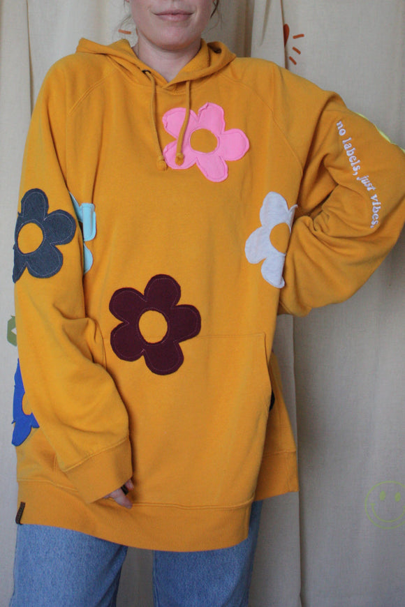 yellow upcycled hoodie with colourful flowers all over, repurposed in canada